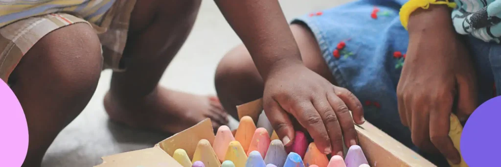 Chi,dren playing with color chalk